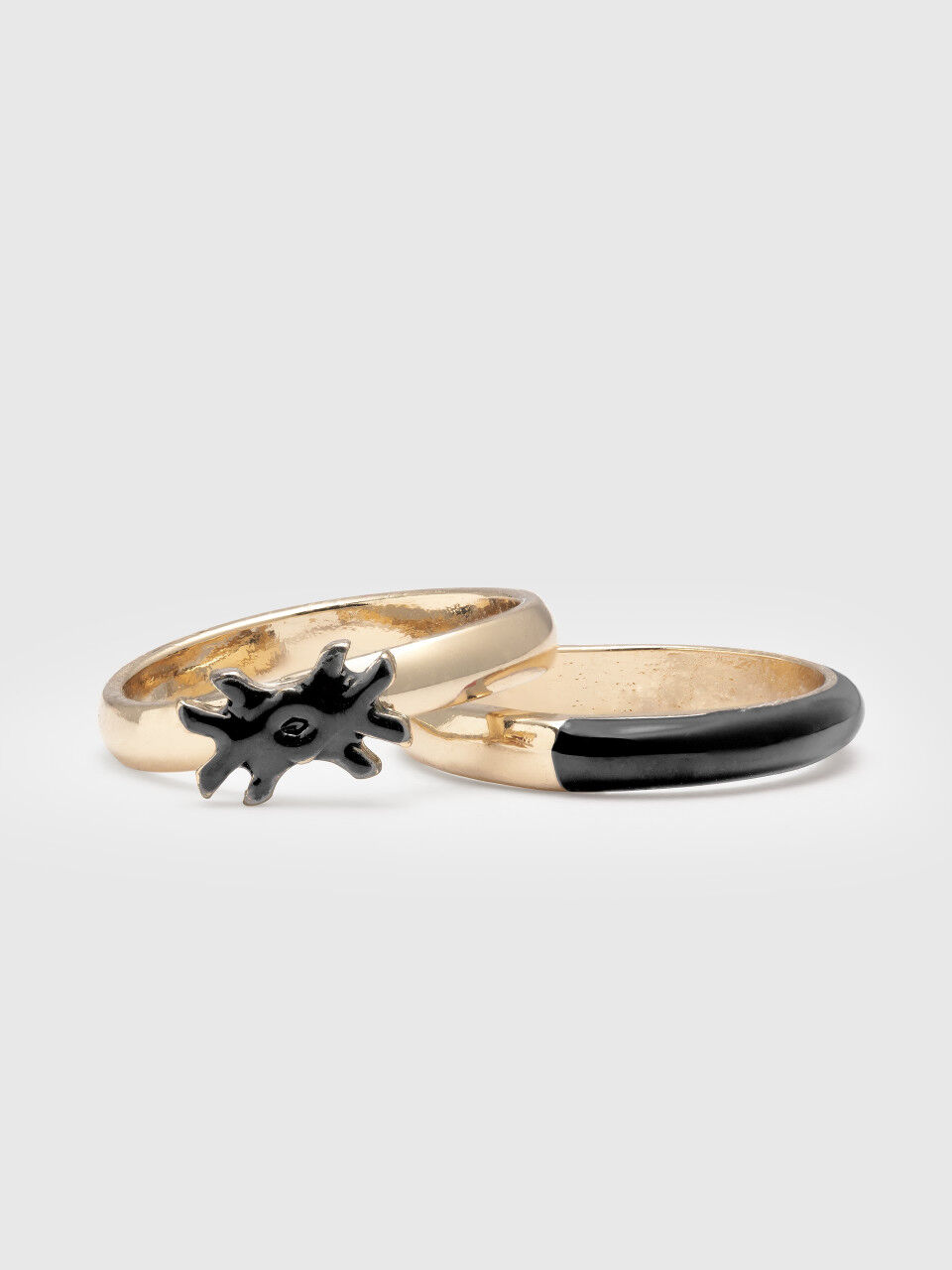 Two rings with black enamelled details