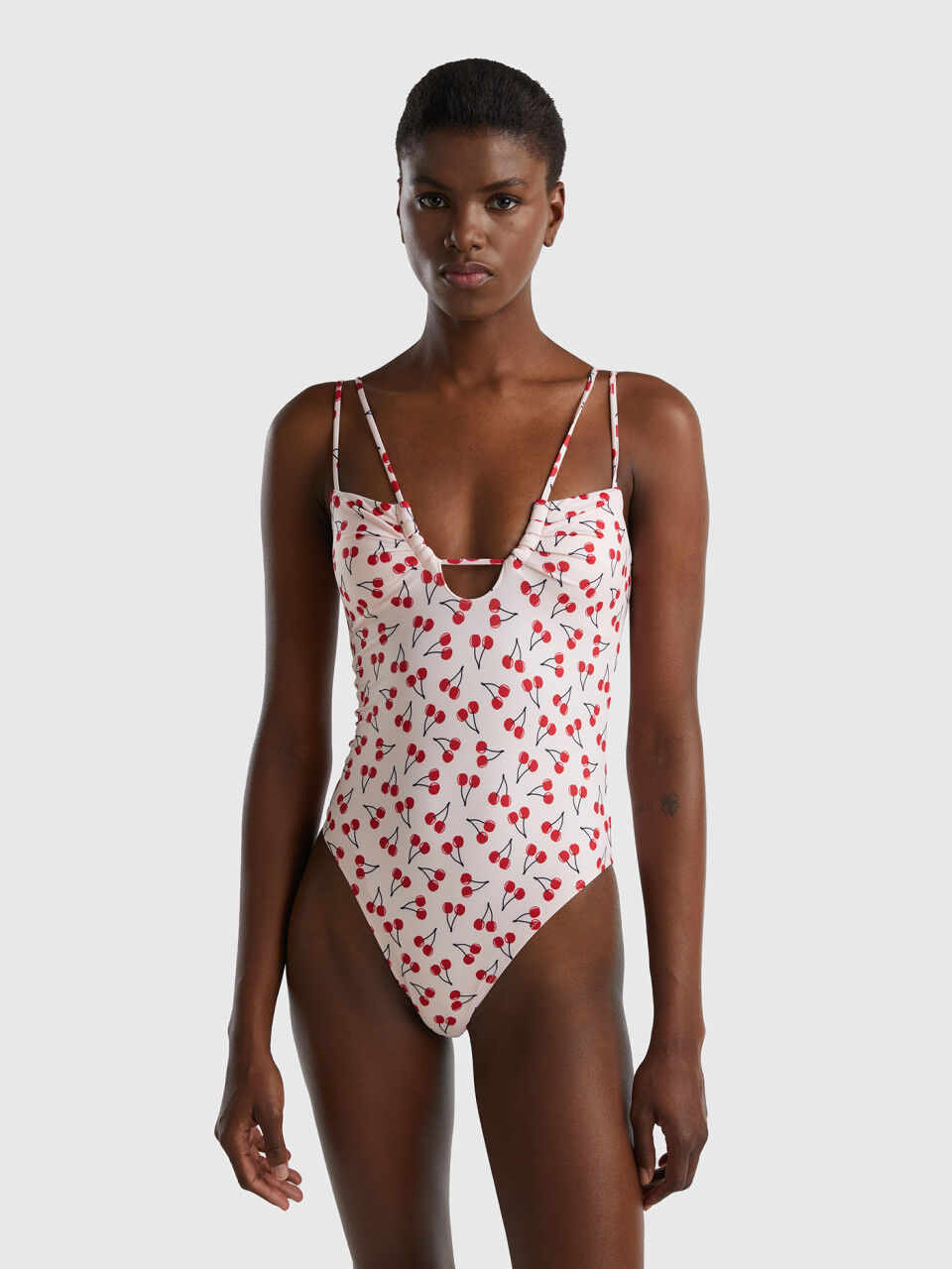 Pink one-piece swimsuit with cherry pattern